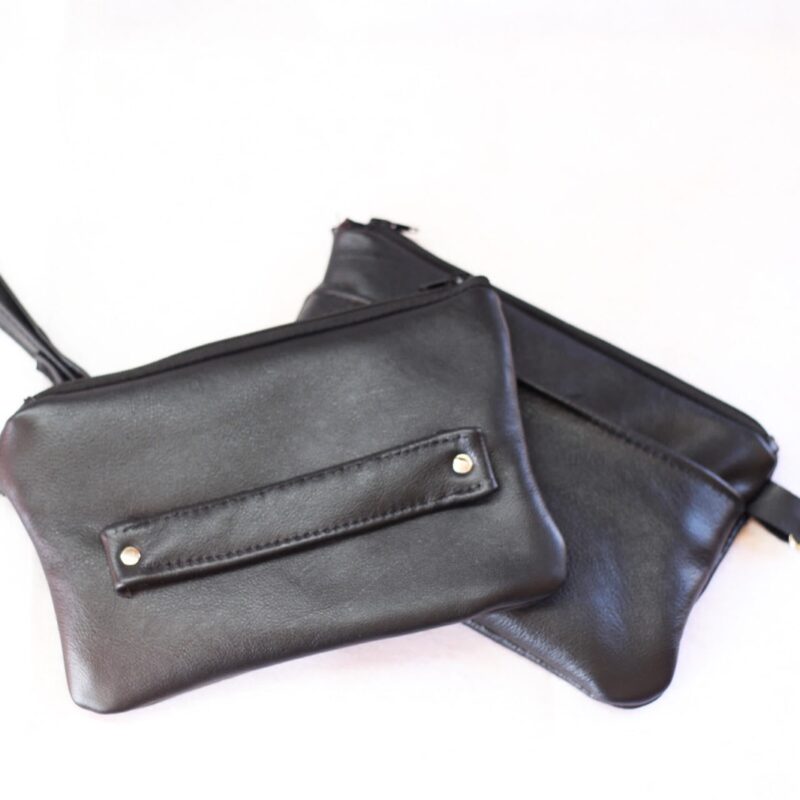 Black clutch made out of black genuine leather.