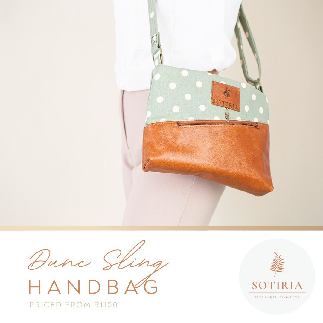 Medium sized handbag. Due tone made from tan coloured genuine leather and light green polka dot cotton. Long adjustable shoulder sling.